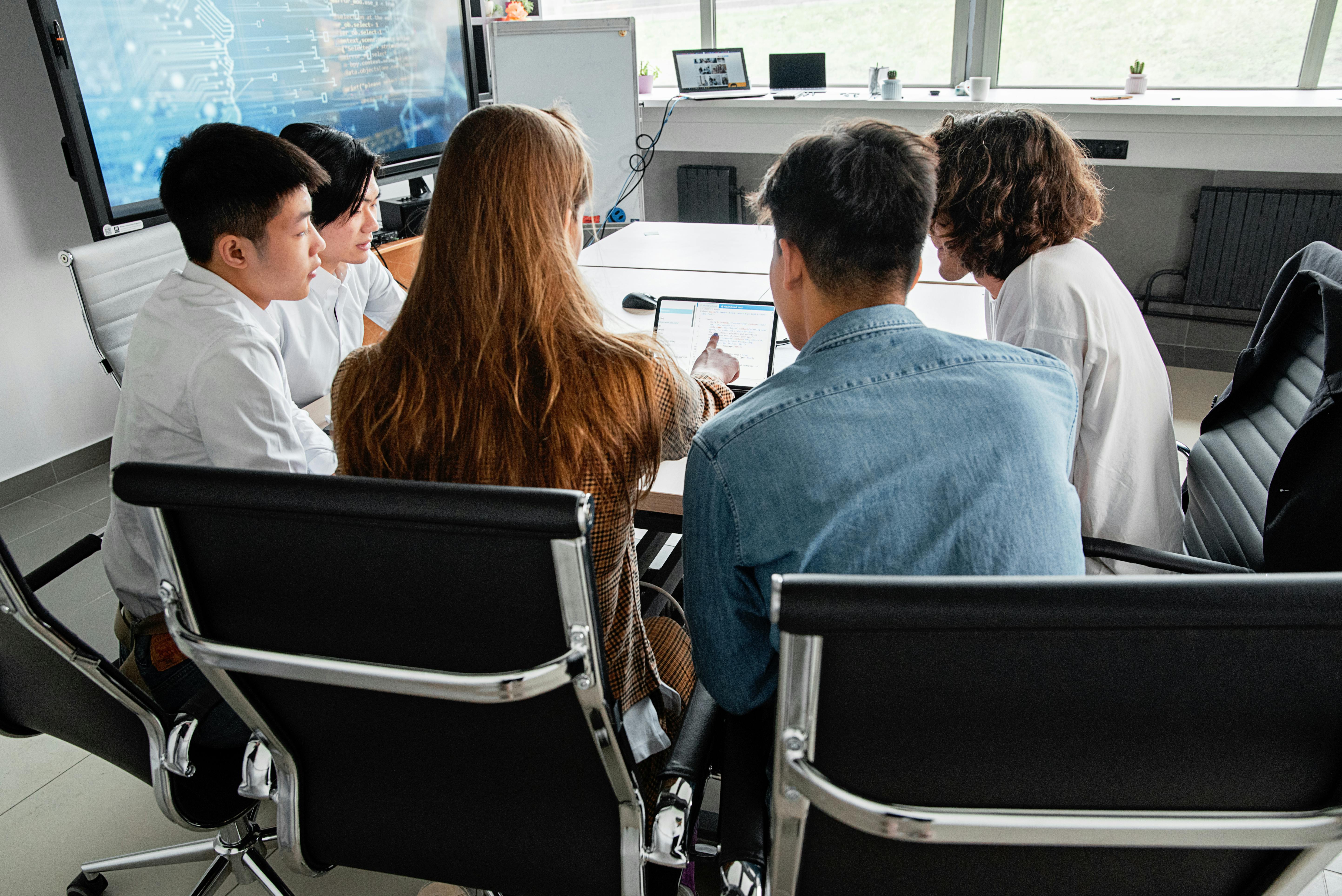 Back office team processing documents at workstation